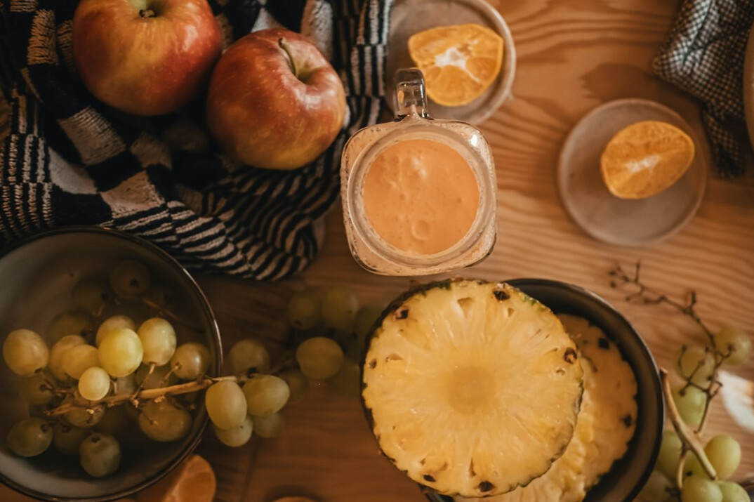 Healthy meal with fresh vegetables and fruit on a wooden table